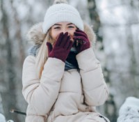 beautiful girl walking on snow-covered winter park