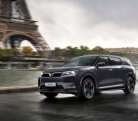 2024-vinfast-vf9-exterior-front-three-quarter-view-driving