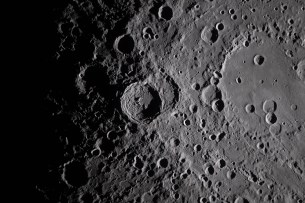 art002e009282 (April 6, 2026) - A close-up view taken by the Artemis II crew of Vavilov Crater on the rim of the older and larger Hertzsprung basin. The right portion of the image shows the transition from smooth material within an inner ring of mountains to more rugged terrain around the rim. Vavilov and other craters and their ejecta are accentuated by long shadows at the terminator, the boundary between lunar day and night. The image was captured with a handheld camera at a focal length of 400 mm, as the crew flew around the far side of the Moon.