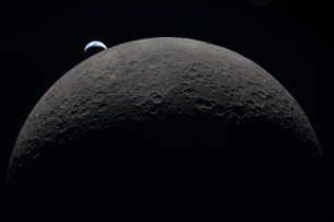 art002e009287 (April 6, 2026) – Earth sets at 6:41 p.m. EDT, April 6, 2026, over the Moon’s curved limb in this photo captured by the Artemis II crew during their journey around the far side of the Moon. Orientale basin is perched on the edge of the visible lunar surface. Hertzsprung Basin appears as two subtle concentric rings, which are interrupted by Vavilov, a younger crater superimposed over the older structure. The lines of indentations are secondary crater chains formed by ejecta from the massive impact that created Orientale.
The dark portion of Earth is experiencing nighttime. On Earth’s day side, swirling clouds are visible over the Australia and Oceania region.