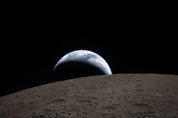 art002e009288 (April 6, 2026) – Earthset captured through the Orion spacecraft window at 6:41 p.m. EDT, April 6, 2026, during the Artemis II crew’s flyby of the Moon. A muted blue Earth with bright white clouds sets behind the cratered lunar surface.
The dark portion of Earth is experiencing nighttime. On Earth’s day side, swirling clouds are visible over the Australia and Oceania region.  
In the foreground, Ohm crater has terraced edges and a flat floor interrupted by central peaks. Central peaks form in complex craters when the lunar surface, liquefied on impact, splashes upwards during the crater’s formation.